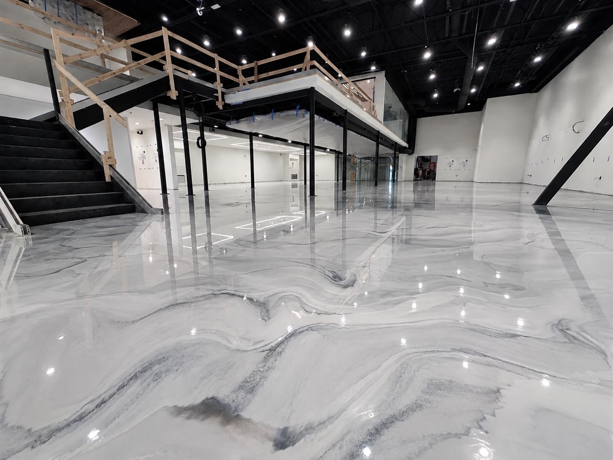 The same commercial space with a glossy white and grey marbled metallic epoxy floor